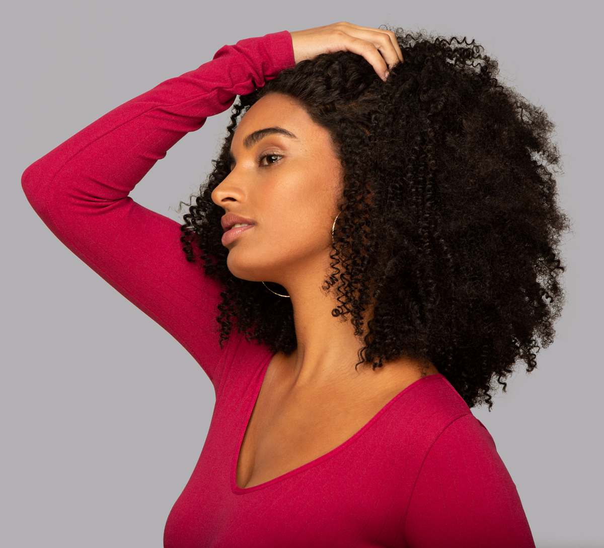 Model wearing a natural black Brazilian curly 13x4 transparent lace frontal