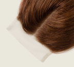 Close-up of transparent lace on a caramel brown straight closure