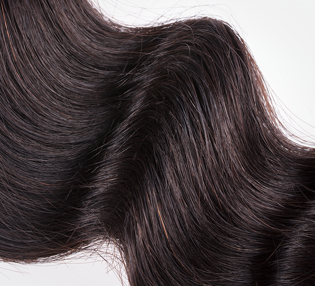 Blonde human hair swatch shown against darker swatches on the ring