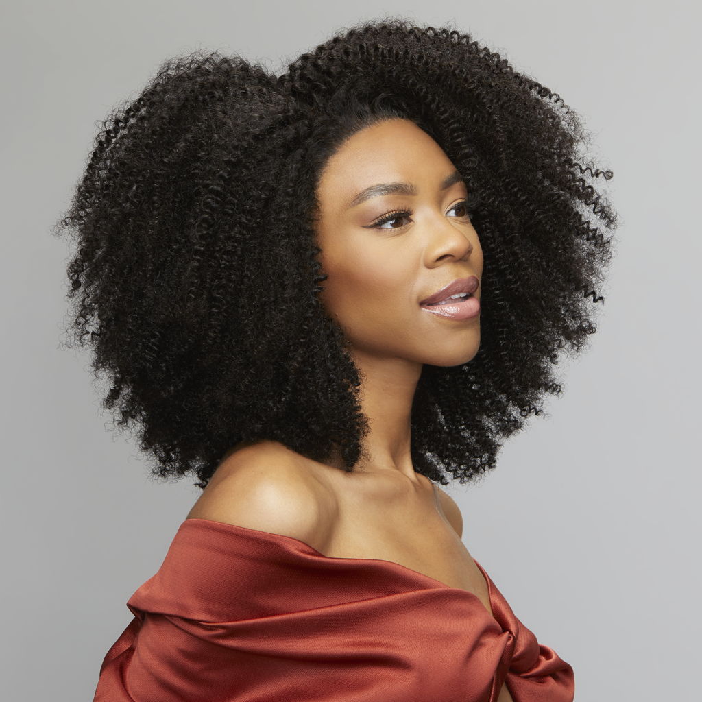 Back view of a Brazilian curly sew-in finished with an HD closure