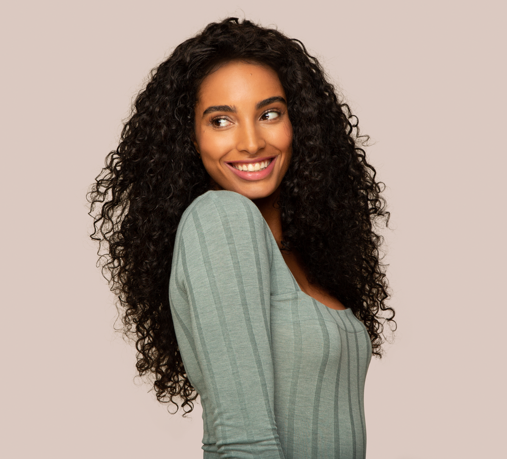 Back view of a Brazilian water wave sew-in showing loose beachy waves