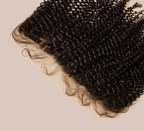 Close-up of transparent lace and coils along a curly frontal hairline