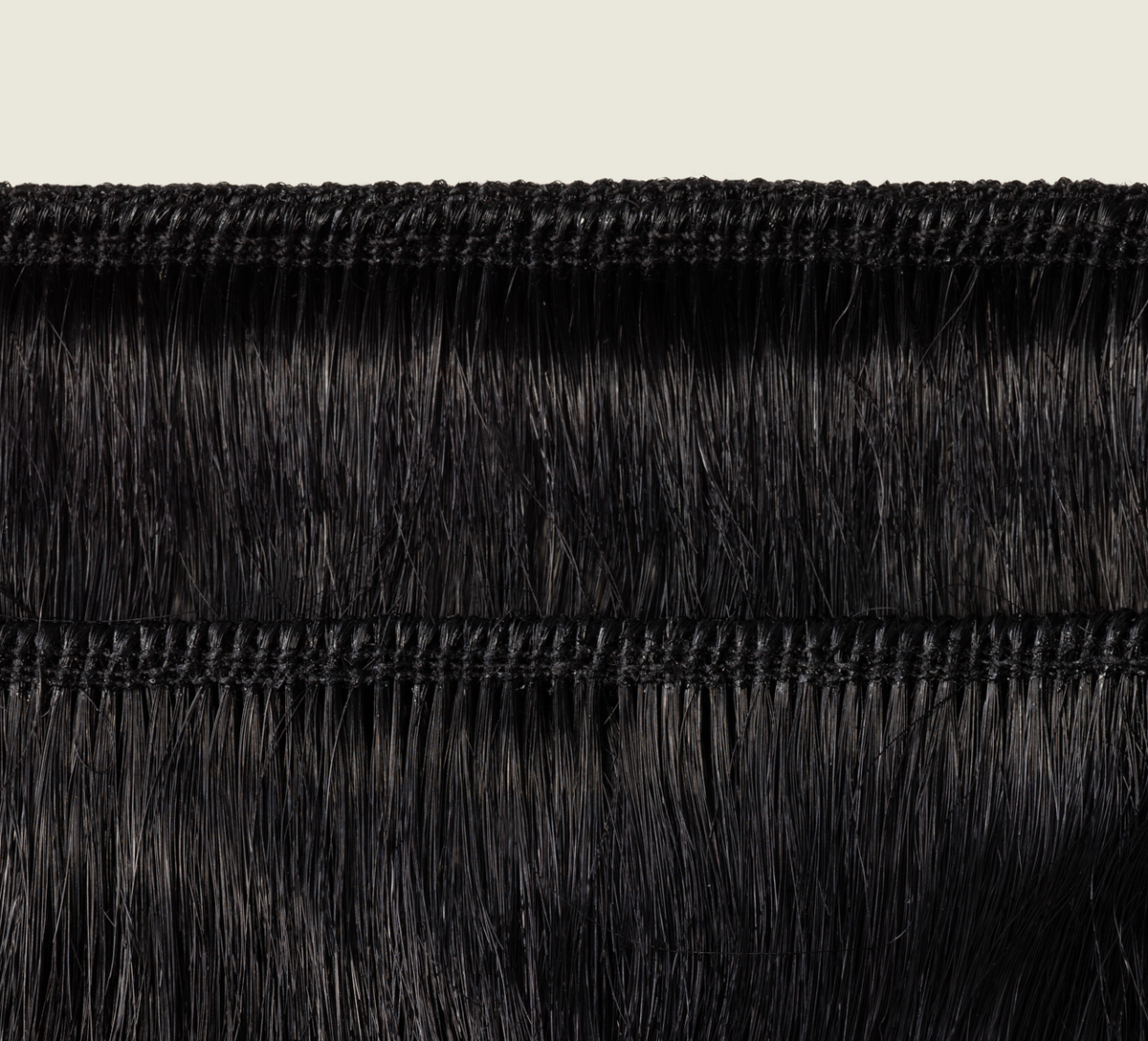 Side view of a jet black straight install styled sleek past the shoulder