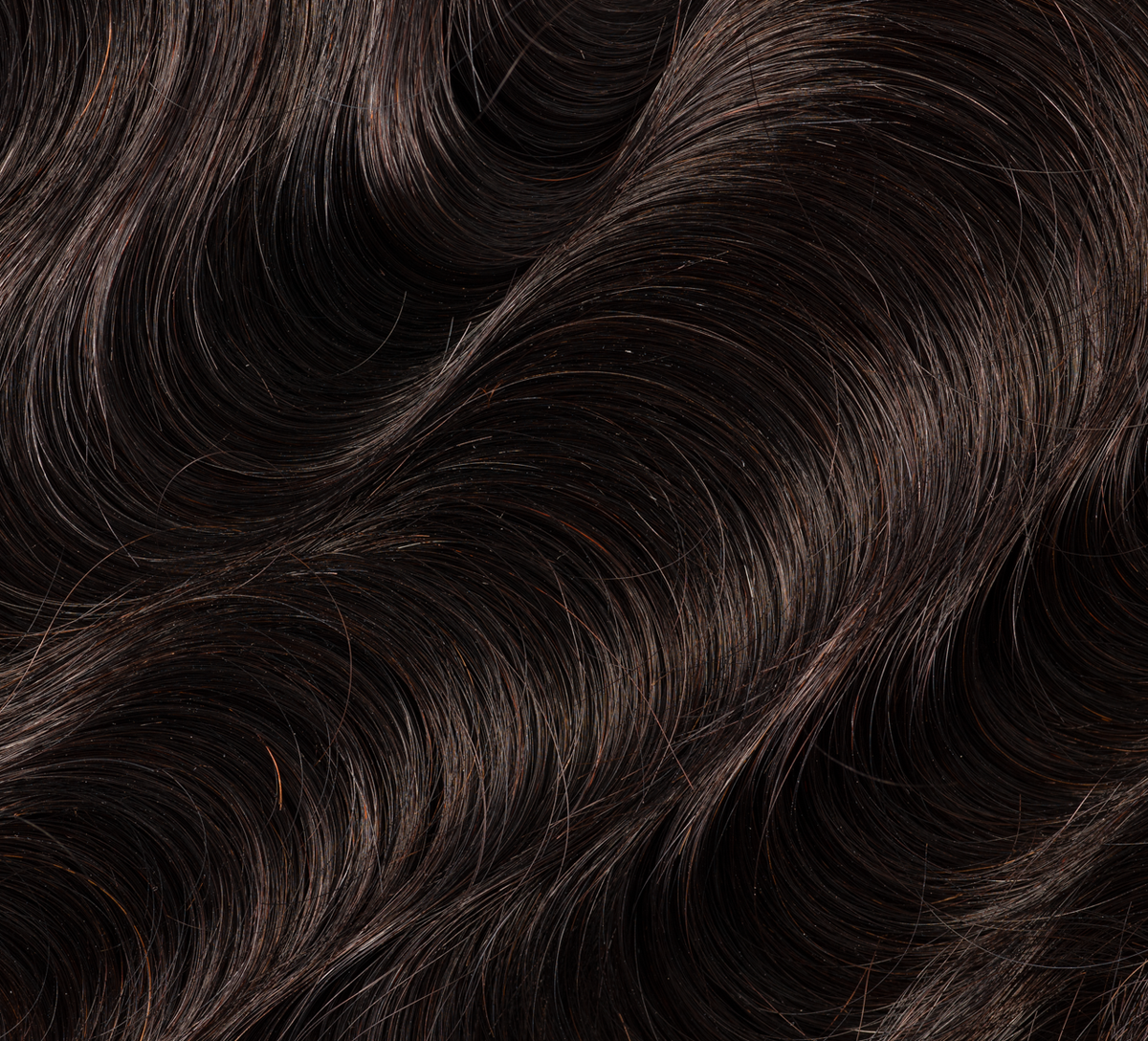 Hand holding a natural black body wave transparent lace closure