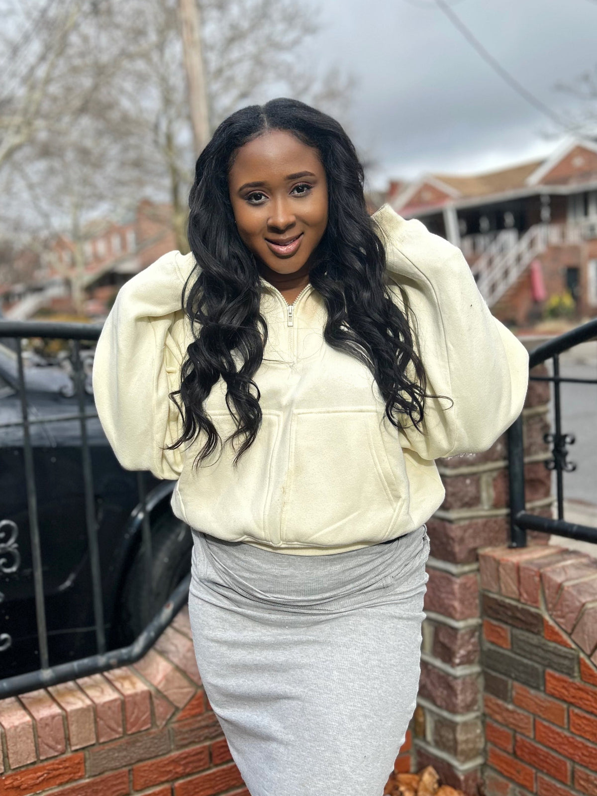 Model wearing a long Brazilian straight sew-in, photographed outdoors