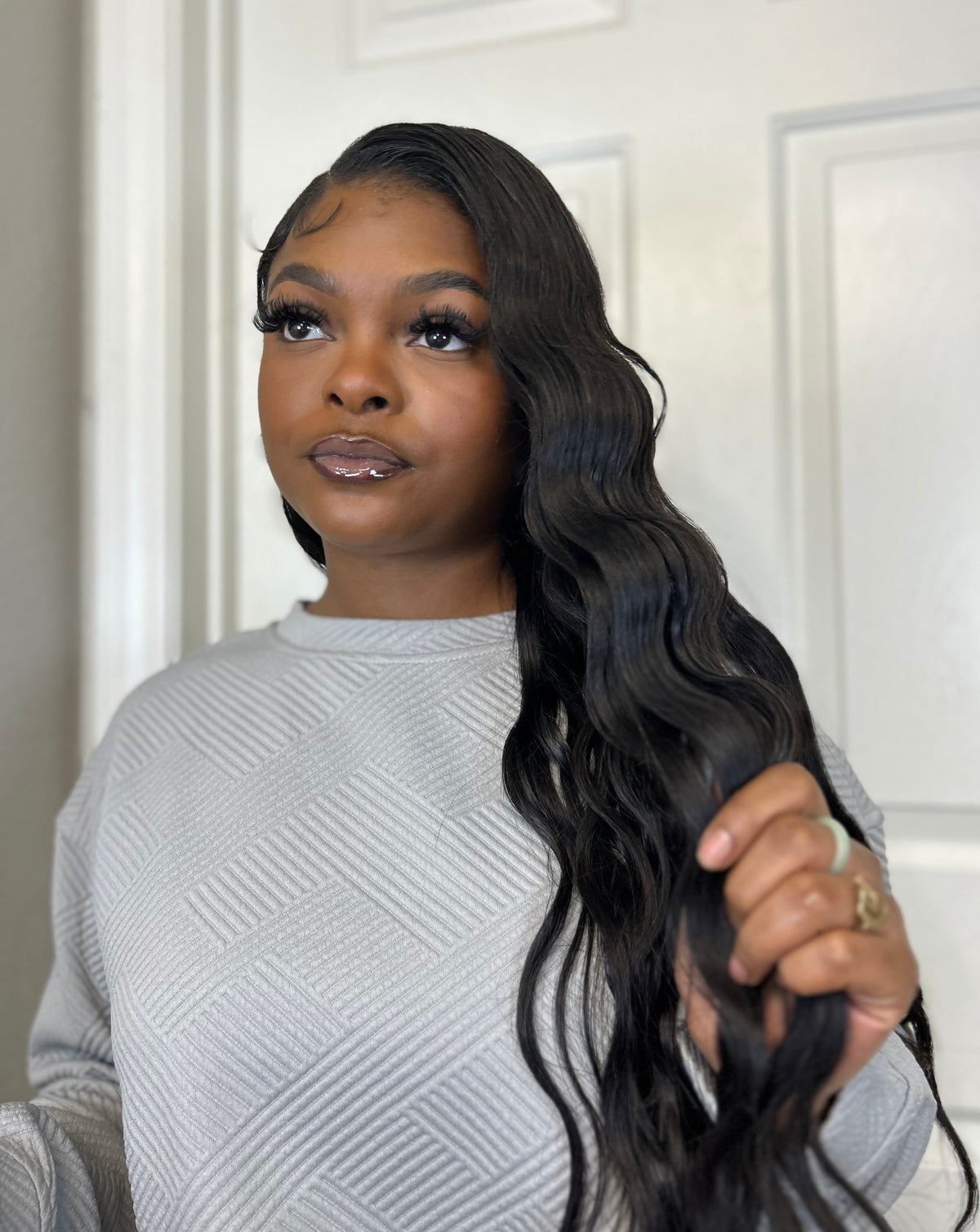 Model wearing Brazilian straight hair styled with a side part