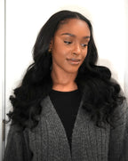 Model wearing Malaysian body wave hair styled in loose curls